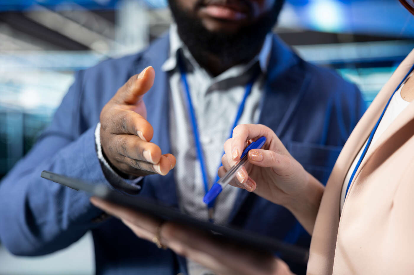 Office workers interacting over a checklist on a tablet